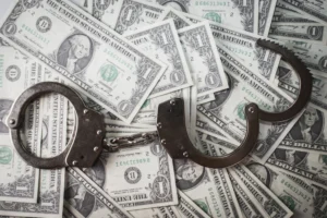 closeup-shot-metal-handcuffs-dollars